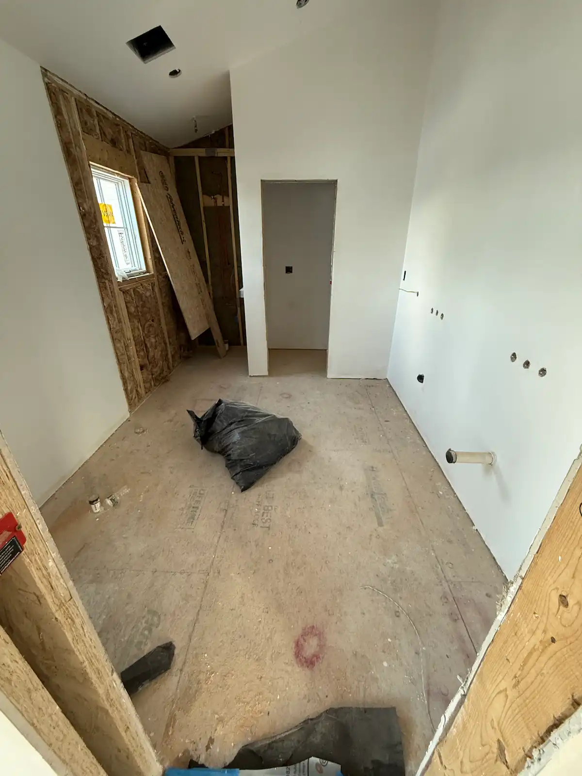 Bathroom before tile installation in Brookline, MA — gutted space ready for new tile work by Davie Mac Tile
