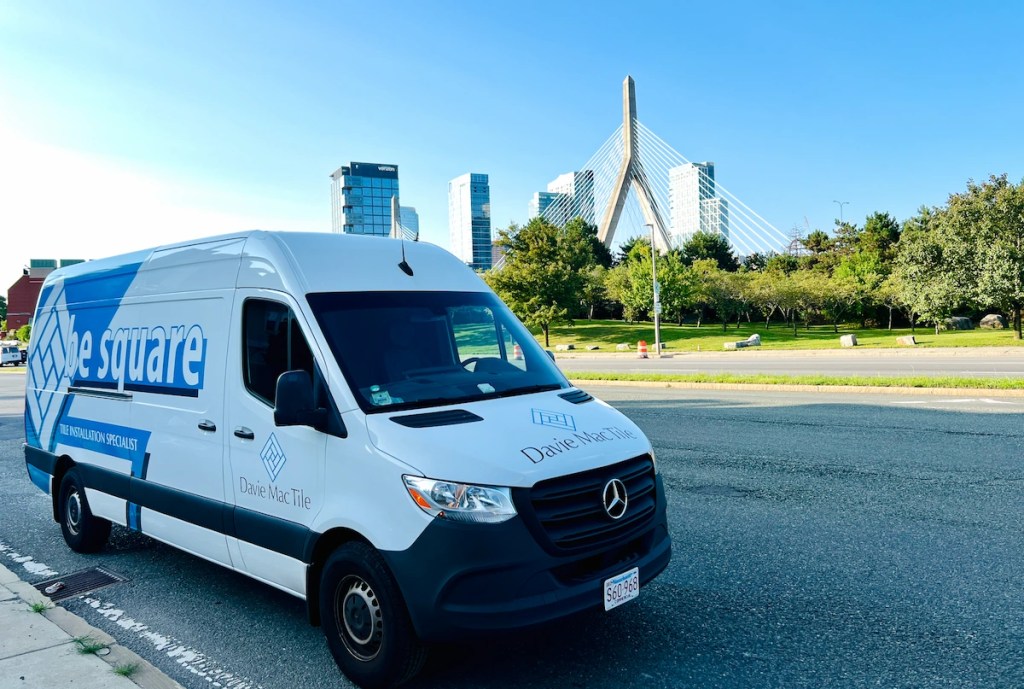 Davie Mac Tile service van with the Boston Zakim Bridge in the background, representing tile installation services across Greater Boston